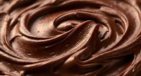 Rich creamy chocolate frosting swirl with smooth glossy texture for baking desserts confectionery culinary food photography backgrounds and sweet treats.