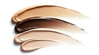 Creamy foundation makeup smears in different nude shades isolated on white background showing texture and coverage for cosmetic beauty products.