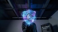 Businessman in suit holding glowing digital security shield with lock icon in modern server room representing cybersecurity and data protection technology.