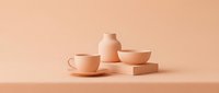 Monochromatic beige ceramic tableware arrangement featuring cup, saucer, vase and geometric blocks on neutral background for minimalist home decor and product design projects.