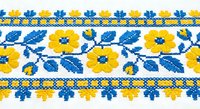 Traditional Ukrainian embroidery pattern with yellow flowers and blue leaves on white fabric. Folk art cross-stitch design for textile decoration and crafts.