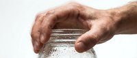 Elderly hands protecting glass of fresh water, symbolizing care, health and hydration needs of senior adults in daily life.