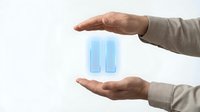Professional hands protecting glowing blue pause symbol representing business control, workflow management, and strategic decision-making concepts.