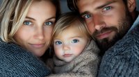 Young family portrait with mother, father and toddler daughter wrapped in cozy knit sweaters, featuring striking blue eyes and intimate emotional connection.