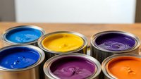 Colorful paint cans with vibrant blue, yellow, purple, orange hues for home renovation, interior design, and creative art projects on wooden surface.