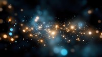 Magical glowing particles and sparkles floating on dark background with blue bokeh lights creating dreamy atmospheric effect. Suitable for festive designs.