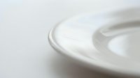 Smooth white cream texture with flowing waves and ripples creating elegant abstract patterns for skincare and cosmetic product backgrounds.