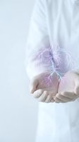 Medical professional cupped hands holding glowing lung anatomy with bronchial tree visualization for respiratory health education and healthcare concepts.