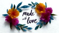Watercolor floral wreath with orange and purple flowers, teal leaves framing handwritten text "made with love" on white background. Perfect for craft projects.