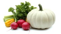 Fresh white pumpkin with bright red radishes, yellow celery stalks and green parsley arranged on pure white background, isolated healthy vegetables composition.