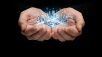 Caucasian male hands holding glowing digital city hologram against black background, representing urban development, smart city technology, and business innovation for corporate and tech applications.