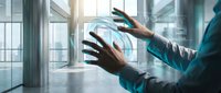Professional businessman using holographic digital interface technology with futuristic data visualization in modern office environment.