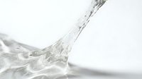 Clear water splashing dynamically against white background, suitable for beverage, health, wellness, and product advertising campaigns.