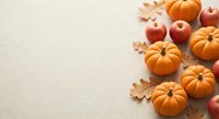 Autumn harvest composition with orange pumpkins, red apples and oak leaves on neutral background for seasonal decorating and thanksgiving celebrations.