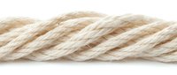 Twisted natural fiber rope with beige and cream tones isolated on white background. Suitable for nautical, maritime, construction, and craft projects.