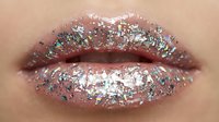 Closeup of lips with shimmering glitter and sparkle makeup, featuring iridescent silver and pink tones for cosmetics, beauty, and festive occasions.