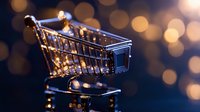 Empty miniature shopping cart with golden bokeh lights in background, symbolizing online shopping and retail commerce.