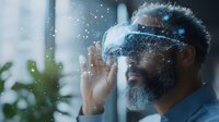 African American mature businessman wearing VR headset with glowing digital particles, exploring augmented reality in modern office environment.