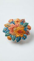 Embroidered floral brooch featuring vibrant yellow, orange, and coral flowers with teal leaves on white background, isolated for design use.