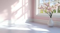 Delicate pink cherry blossoms in white ceramic vase by window, soft natural light casting shadows on pale pink walls and white floor.