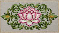 Embroidered pink lotus flower with ornate green foliage scrollwork on beige fabric background. Decorative floral needlework design for textile crafts.