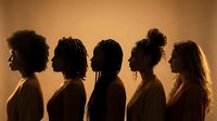 Five diverse women in profile silhouette against warm golden background showcasing different hairstyles and ethnicities for beauty diversity concepts.