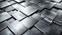 Metallic brushed steel tiles arranged in geometric pattern creating dynamic surface with light reflection and shadows. Modern industrial background.