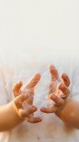 Cupped hands holding glowing energy light with magical sparkles and warm illumination for spiritual healing and wellness concepts.