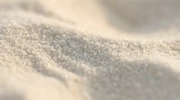 Fine golden sand grains with soft natural lighting creating gentle waves and textures for beach vacation and summer holiday concepts.