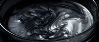Dark swirling liquid paint creates mesmerizing abstract patterns in black bowl. Fluid art texture with metallic sheen for creative design projects.