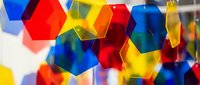 Colorful translucent geometric hexagons with vibrant red, blue, yellow and orange tones creating an abstract composition for design projects.