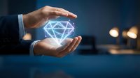 Businessman hands protecting glowing diamond hologram symbol representing luxury, value protection, precious investment and wealth management concept.