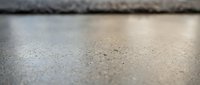 Concrete surface with fine dust particles and shallow depth of field, suitable for backgrounds, textures, and construction-related projects.