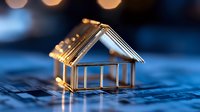 Small metallic house model on circuit board with glowing lights, representing smart home technology and digital real estate innovation against blue background.