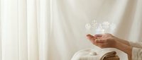 Female hands holding glowing digital icons representing connectivity and technology in soft natural lighting for modern lifestyle concepts.