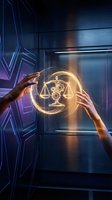 Hands touching glowing digital justice scales hologram in futuristic sci-fi interior with blue neon lighting and metallic surfaces for legal technology concepts.