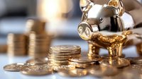 Golden piggy bank surrounded by stacked coins on reflective surface with soft bokeh background, representing savings, investment and financial planning.