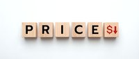 Wooden letter blocks spelling PRICE with red dollar sign and down arrow on white background for business and finance concepts.