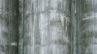Aged concrete wall texture with weathered gray surface, moss stains, and vertical streaks for grunge backgrounds and architectural design.