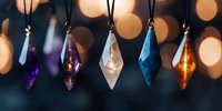 Colorful crystal pendants hanging on strings against blurred bokeh lights background, creating magical mystical atmosphere for spiritual and decorative designs.