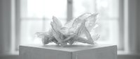 Crumpled paper balls on white surface near window with natural lighting for office waste concept and creative block representation.