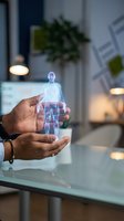 Hands holding holographic human body projection with medical data visualization in modern office environment for healthcare technology applications.