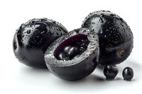 Fresh acai berries with water drops, whole and cut in half showing dark purple flesh on white background, macro food photography for healthy eating concept.