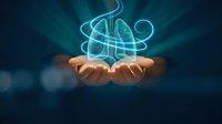 Glowing lungs hologram floating above open hands representing respiratory health, medical technology and healthcare innovation concepts.
