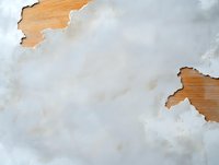 Torn paper effect revealing wooden texture underneath against light gray watercolor background, creating layered artistic composition for design projects.