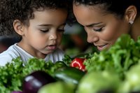 African American mother and young child exploring fresh vegetables together, sharing healthy eating habits and kitchen education in warm natural light.