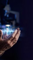 Senior scientist hands displaying glowing sound wave hologram in laboratory setting with microscope background for medical research and technology concepts.