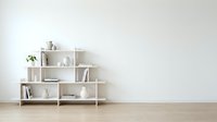 Modern white geometric bookshelf with books and decor items against minimalist wall in contemporary living room interior design for home organization.
