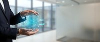 Business professional holding glowing digital network sphere with connected dots representing global connectivity and data technology solutions.