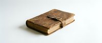 Antique leather-bound journal with aged pages and string closure, isolated on white background, suitable for historical, literary, educational, and design projects.